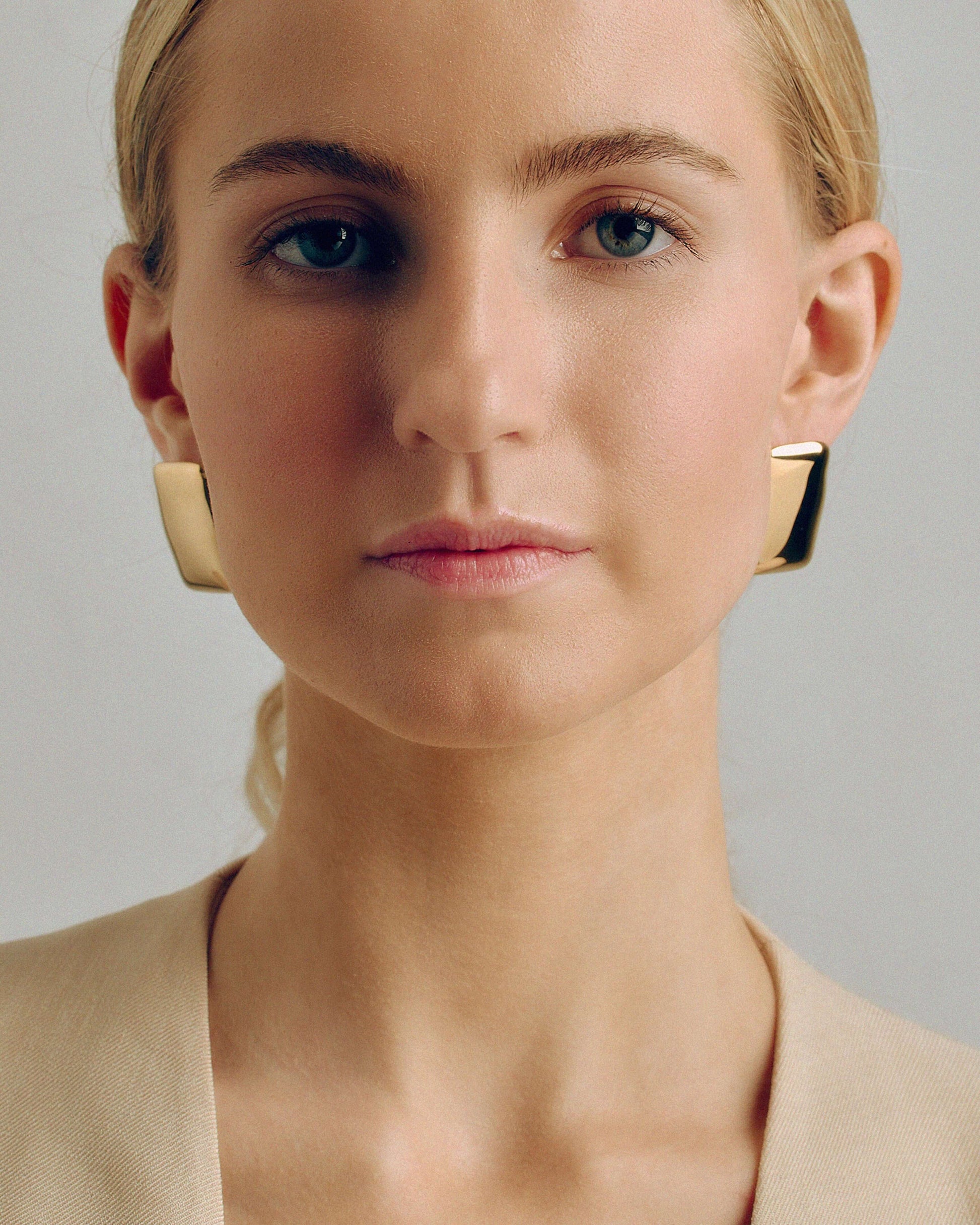 Bold gold rectangle stud earrings with a chunky, sculptural design and high-shine finish. Modern geometric statement studs perfect for everyday or occasion wear.