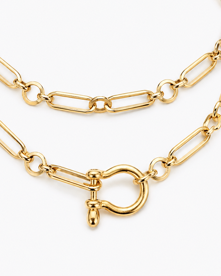 A close-up of a gold-toned paperclip chain necklace with a toggle clasp, shown on a clean white background.