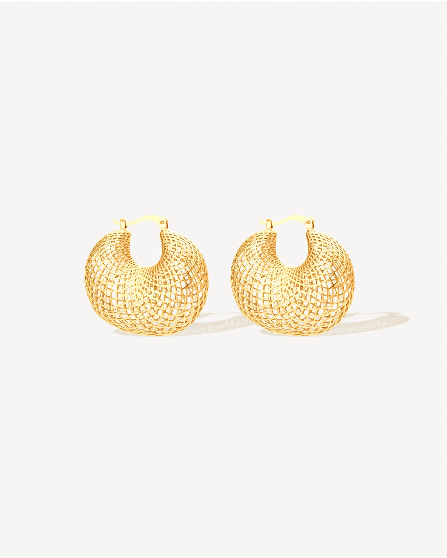 Gold mesh hoop earrings with sculptural lattice openwork design, bold lightweight statement hoops for women, modern gold-plated stainless steel jewelry, non-tarnish and water-resistant contemporary earrings, fashion-forward sculptural hoop earrings perfect for everyday wear, evening looks, and modern statement jewelry collections.
