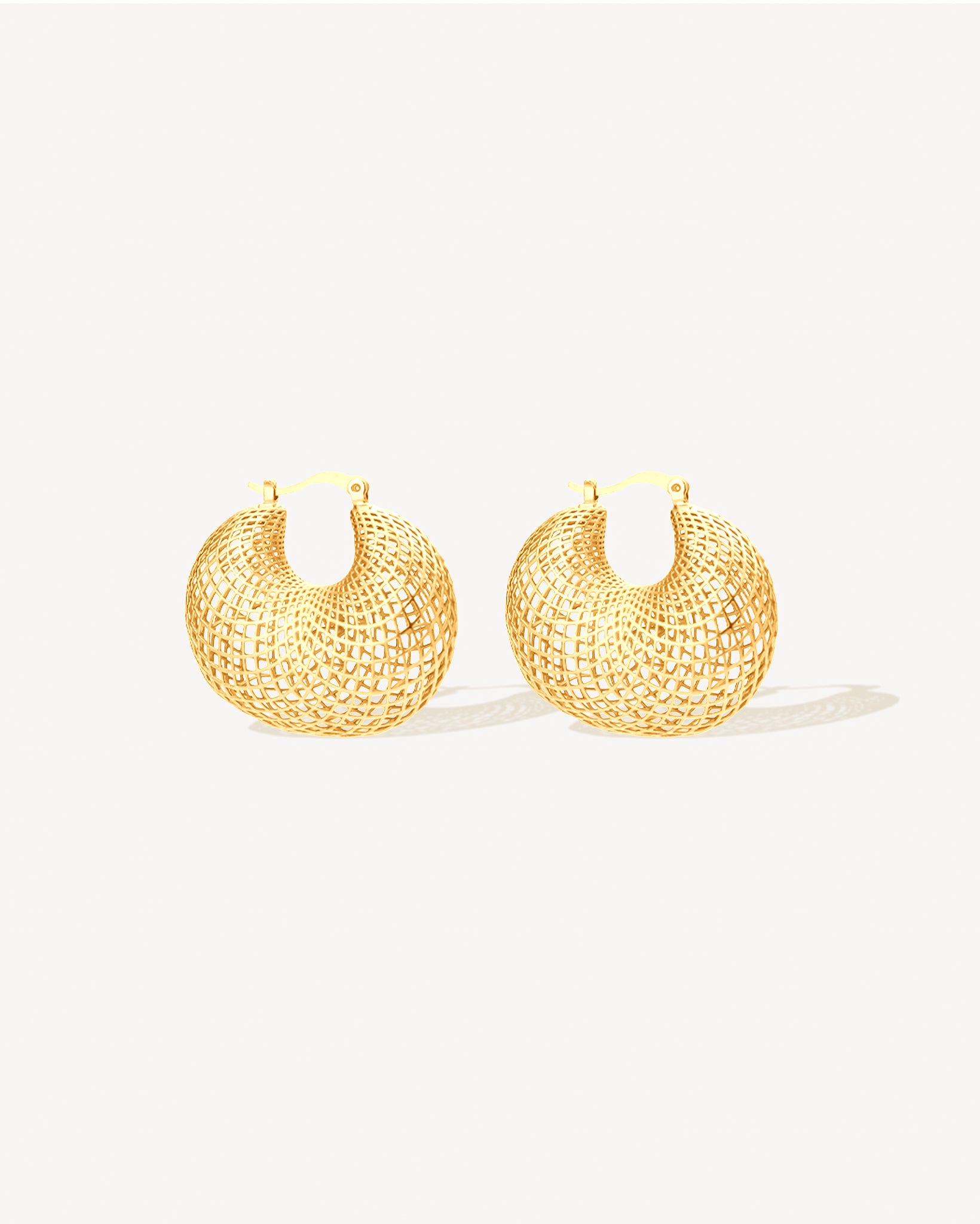 Gold mesh hoop earrings with sculptural lattice openwork design, bold lightweight statement hoops for women, modern gold-plated stainless steel jewelry, non-tarnish and water-resistant contemporary earrings, fashion-forward sculptural hoop earrings perfect for everyday wear, evening looks, and modern statement jewelry collections.