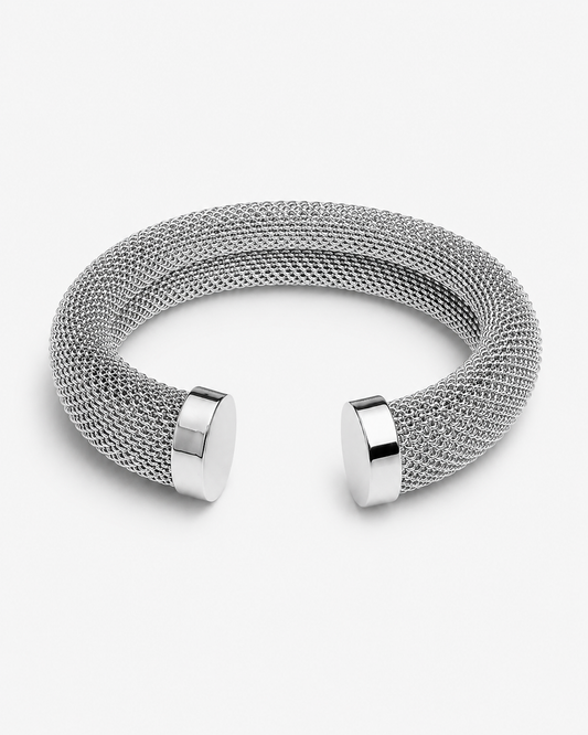 Mesh cuff bracelet close-up showing detailed woven texture, polished metal ends and sculptural open bangle shape