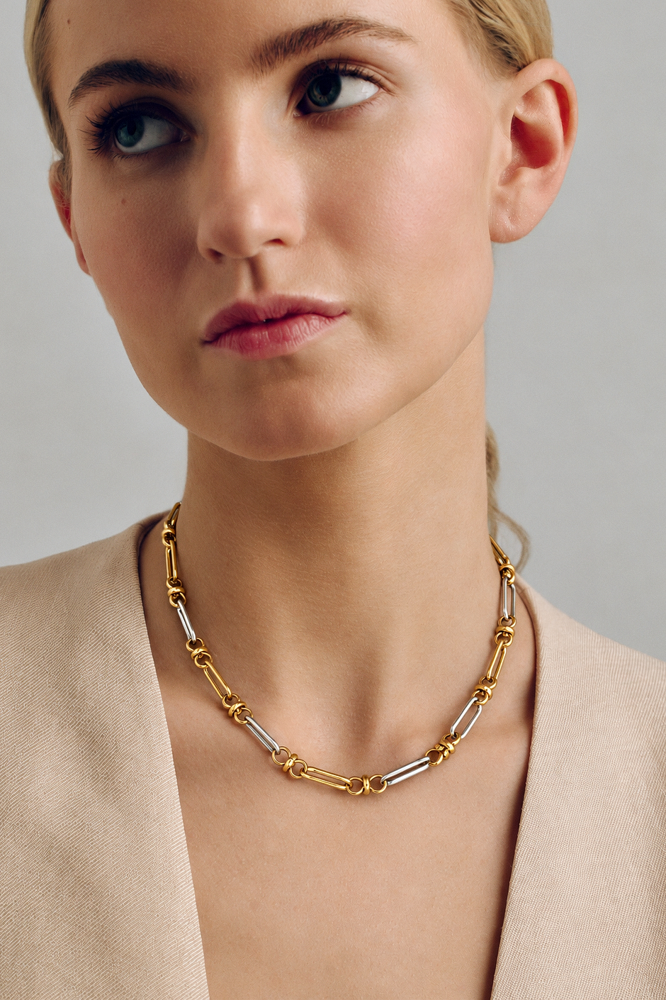 Two tone link chain necklace in polished gold and silver with alternating elongated links, sculptural connectors and a modern mixed metal statement design by RRule