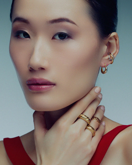 Two-tone ear cuff featuring a sleek wrap-around design in gold and silver, offering a modern, non-pierced accessory for versatile styling.