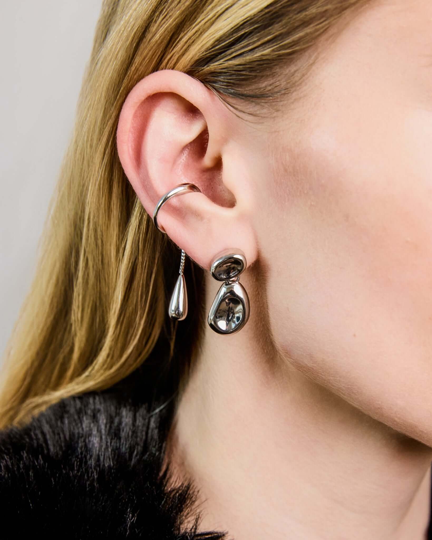 Double Bean Drop Earrings in gold or silver finish featuring a sculptural organic bean design, polished statement drop earrings, modern minimalist jewelry, chunky contemporary earrings for everyday wear and special occasions.
