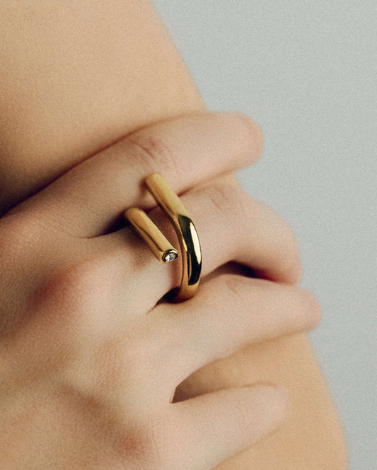 Gold open twist ring with sculptural wrap design, minimal statement band for stacking or solo wear