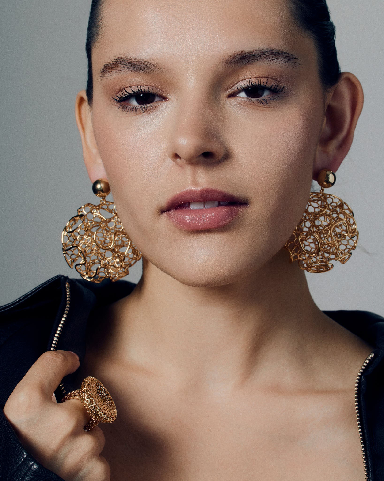Gold filigree statement earrings featuring a sculptural open-work orb design with intricate detailing and polished gold finish. These large hollow drop earrings blend traditional filigree artistry with a modern, sculptural form, creating a bold yet refined statement. Perfect for those who love elegant, lightweight, and wearable art jewelry.