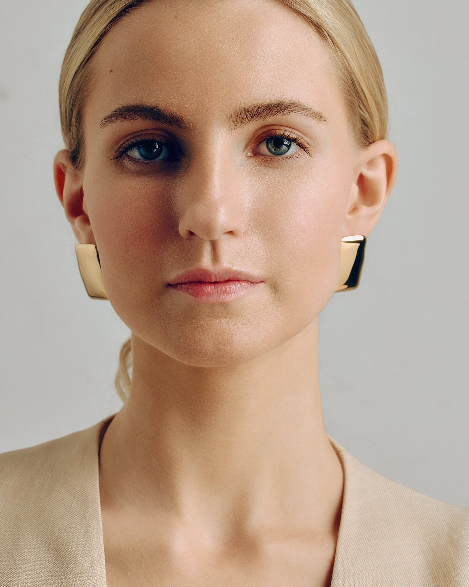 Oversized rectangular gold stud earrings featuring a smooth, polished surface and sculptural shape. These chunky geometric earrings are crafted from high-quality stainless steel with 18K gold coating for a refined, modern look. Perfect statement studs for everyday wear or special occasions — bold yet minimal, designed to complement any outfit.