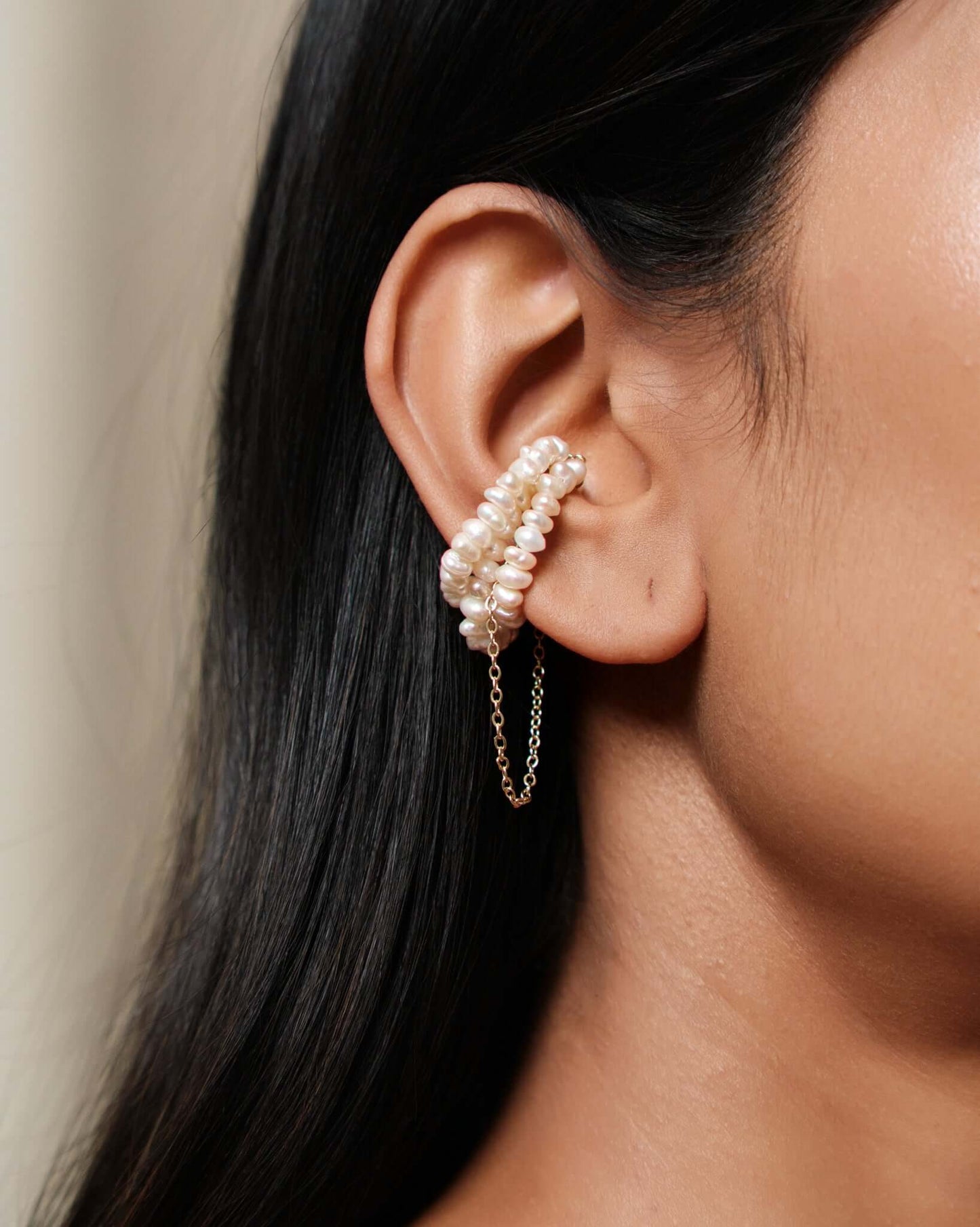 Freshwater pearl ear cuff with gold chain detail, no piercing cartilage cuff worn on ear