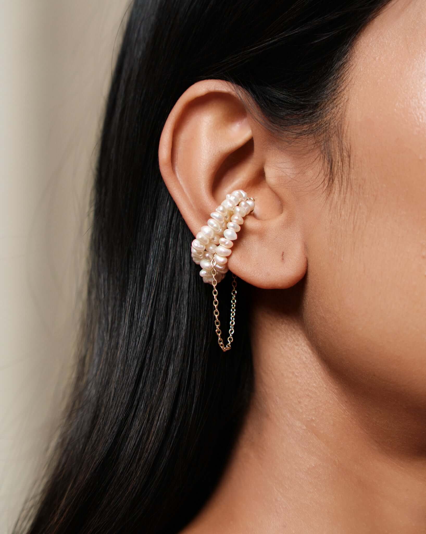 Freshwater pearl ear cuff with gold chain detail, no piercing cartilage cuff worn on ear