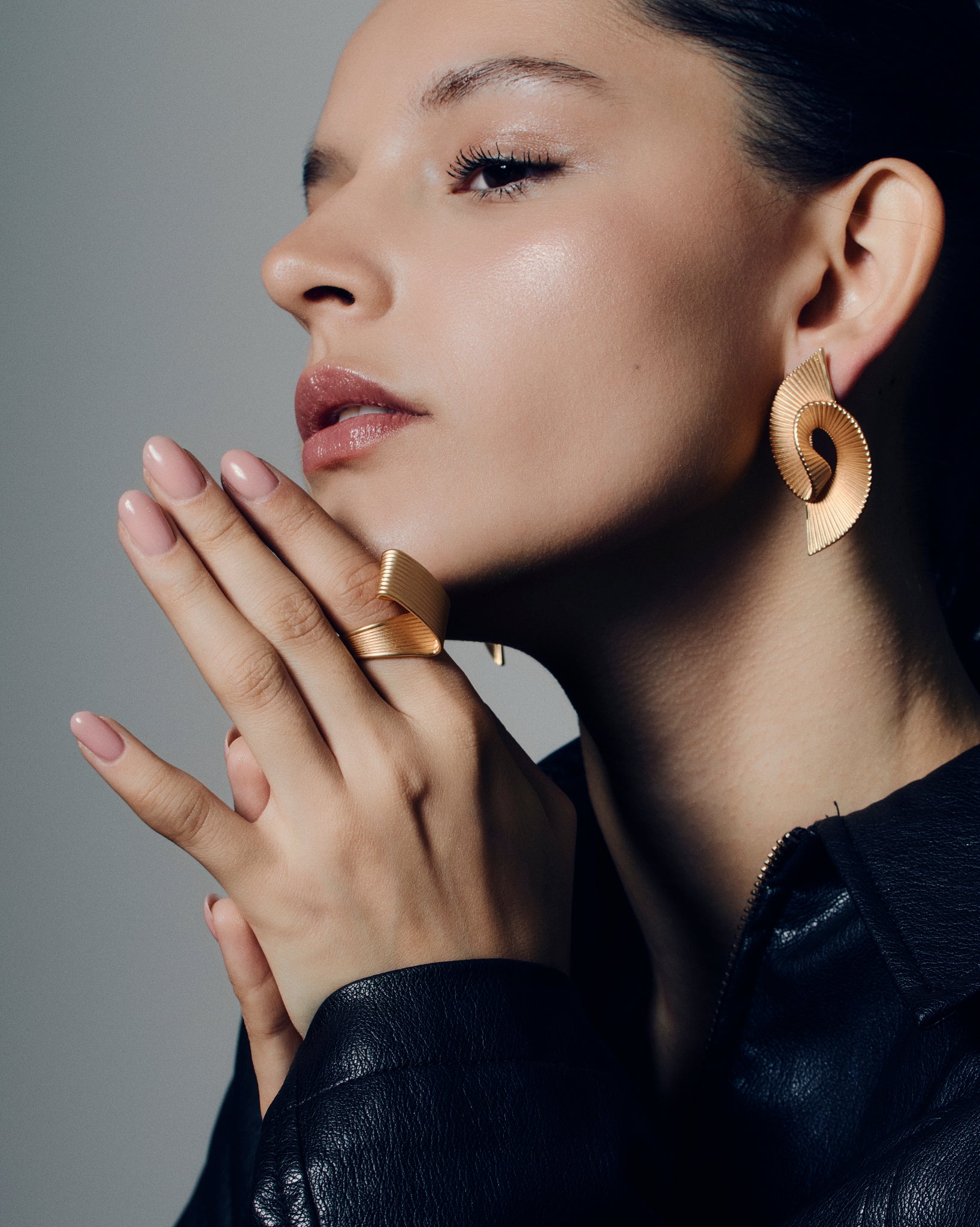 Pleated square gold ring featuring fine ridged detailing that flows seamlessly across the face and band. This sculptural textured ring combines a bold square shape with a soft pleated design, balancing modern geometry and fluid form. Crafted in polished gold-tone metal, it’s a statement piece for everyday or occasion wear.