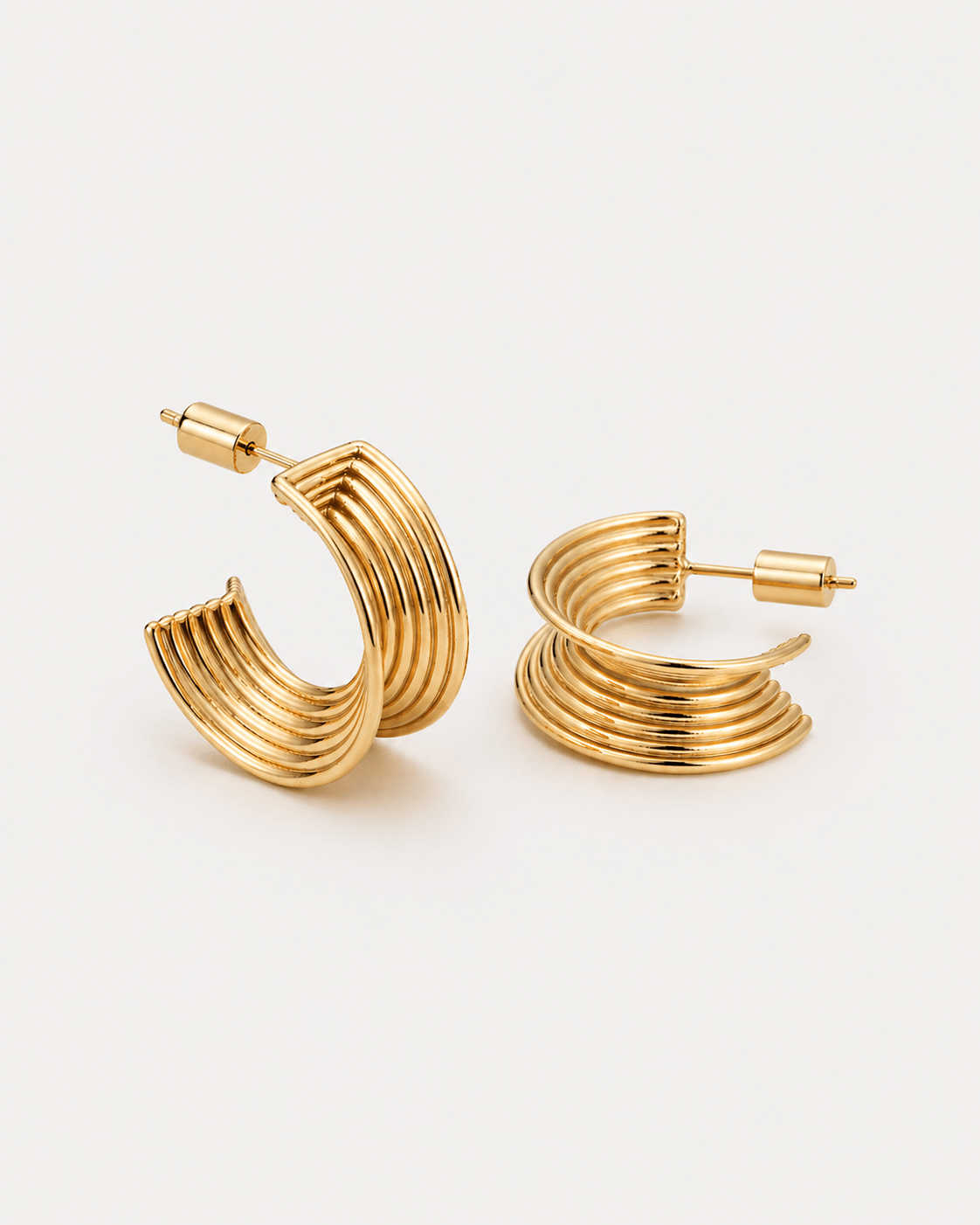Chunky ribbed hoop earrings in gold finish, bold textured hoop earrings for women, modern statement hoops, layered ribbed design jewelry, trendy chunky gold earrings for everyday wear or elevated styling