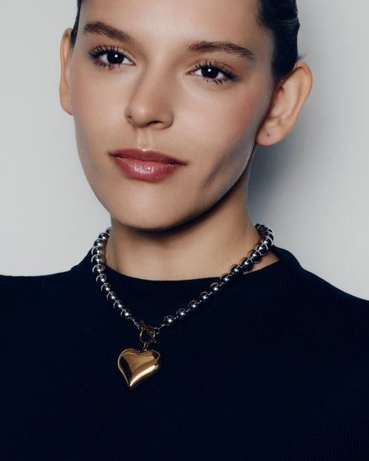 Two tone heart pendant necklace with polished gold heart charm on silver ball chain and front toggle clasp chunky statement jewelry for women