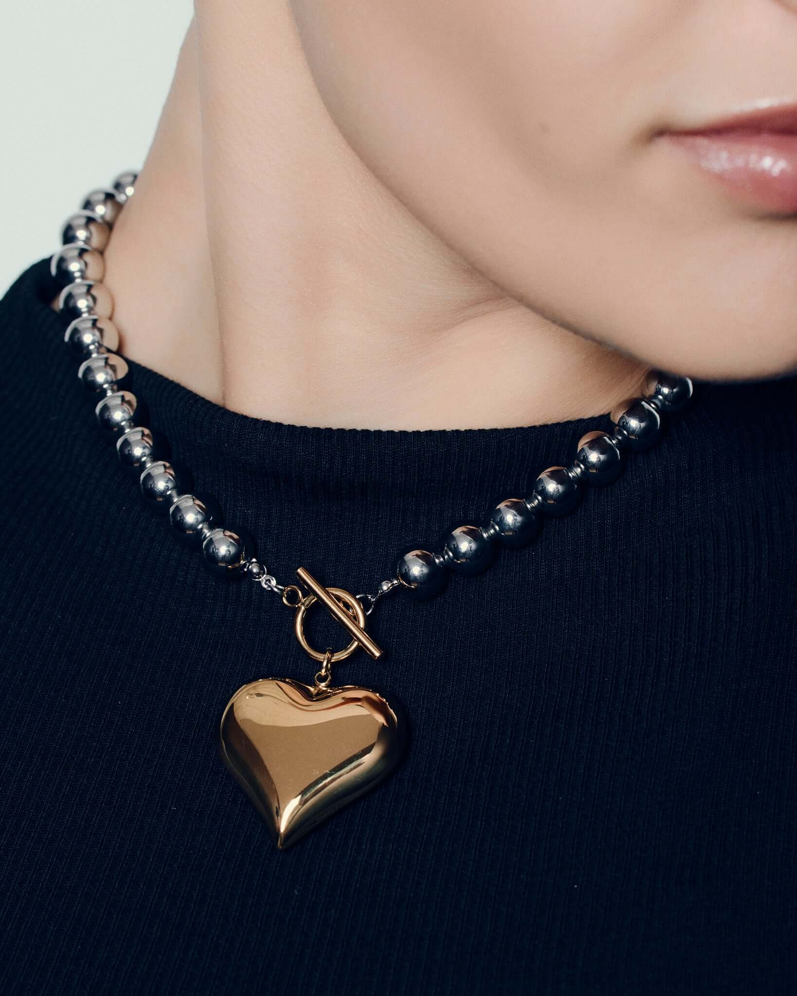 Two tone heart pendant necklace with polished gold heart charm on silver ball chain and front toggle clasp chunky statement jewelry for women