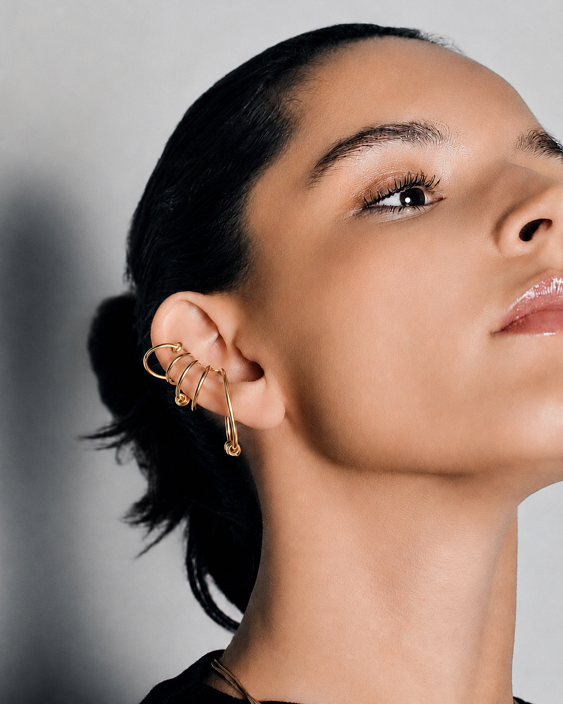 Statement ear cuff in gold featuring a sculptural multi loop design