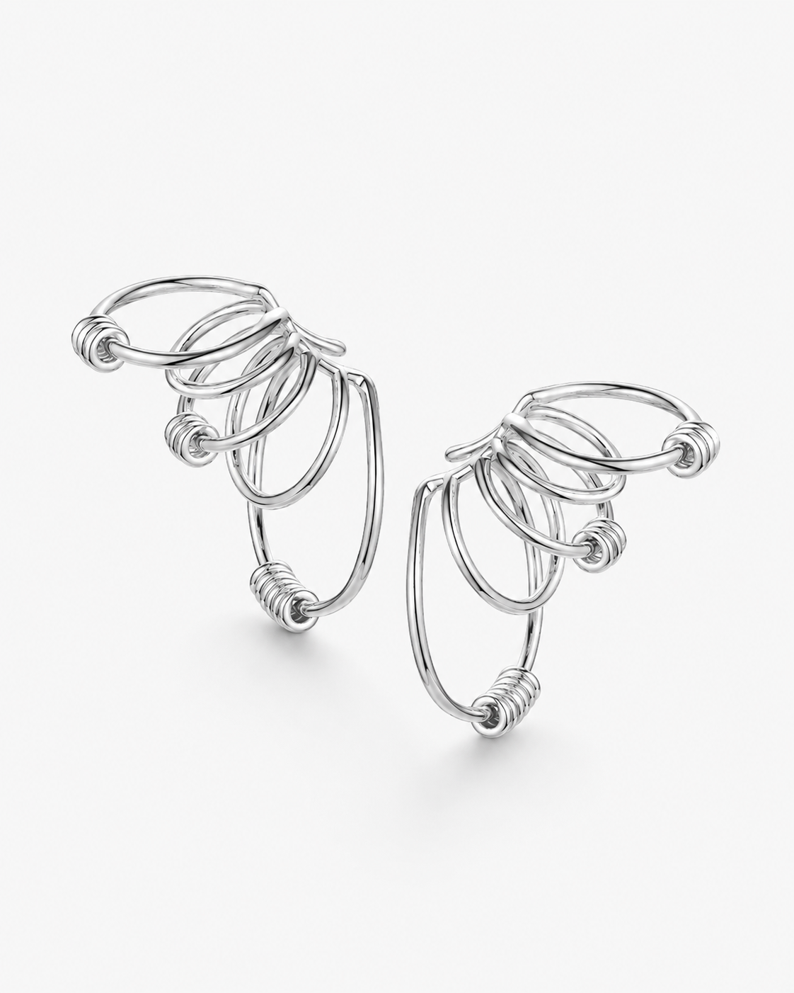 Statement ear cuff in gold featuring a sculptural multi loop design