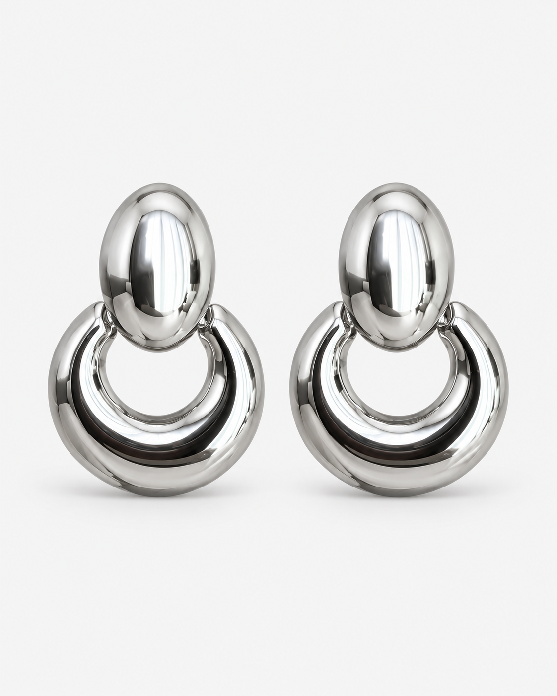 Chunky oval drop earrings in gold and silver, polished statement earrings with a sculptural open hoop design, modern bold jewelry by RRule