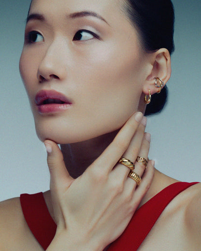 Two-tone ear cuff featuring a sleek wrap-around design in gold and silver, offering a modern, non-pierced accessory for versatile styling.