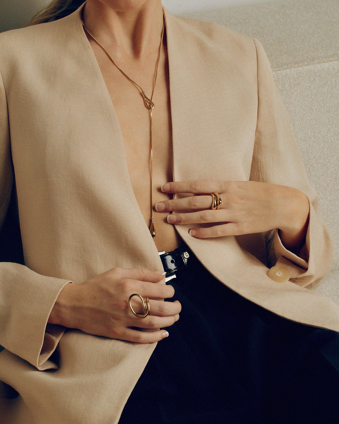 Gold layered sculptural ring with smooth stacked design, minimal statement band worn on hand