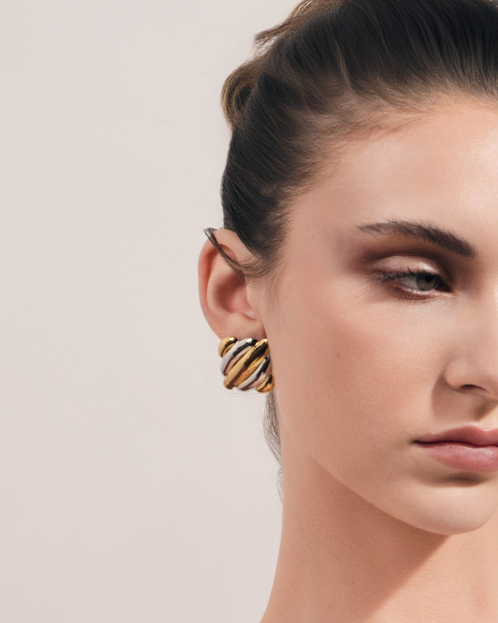 Chunky ribbed two-tone gold and silver square stud earrings with sculptural dome design for modern everyday wear.