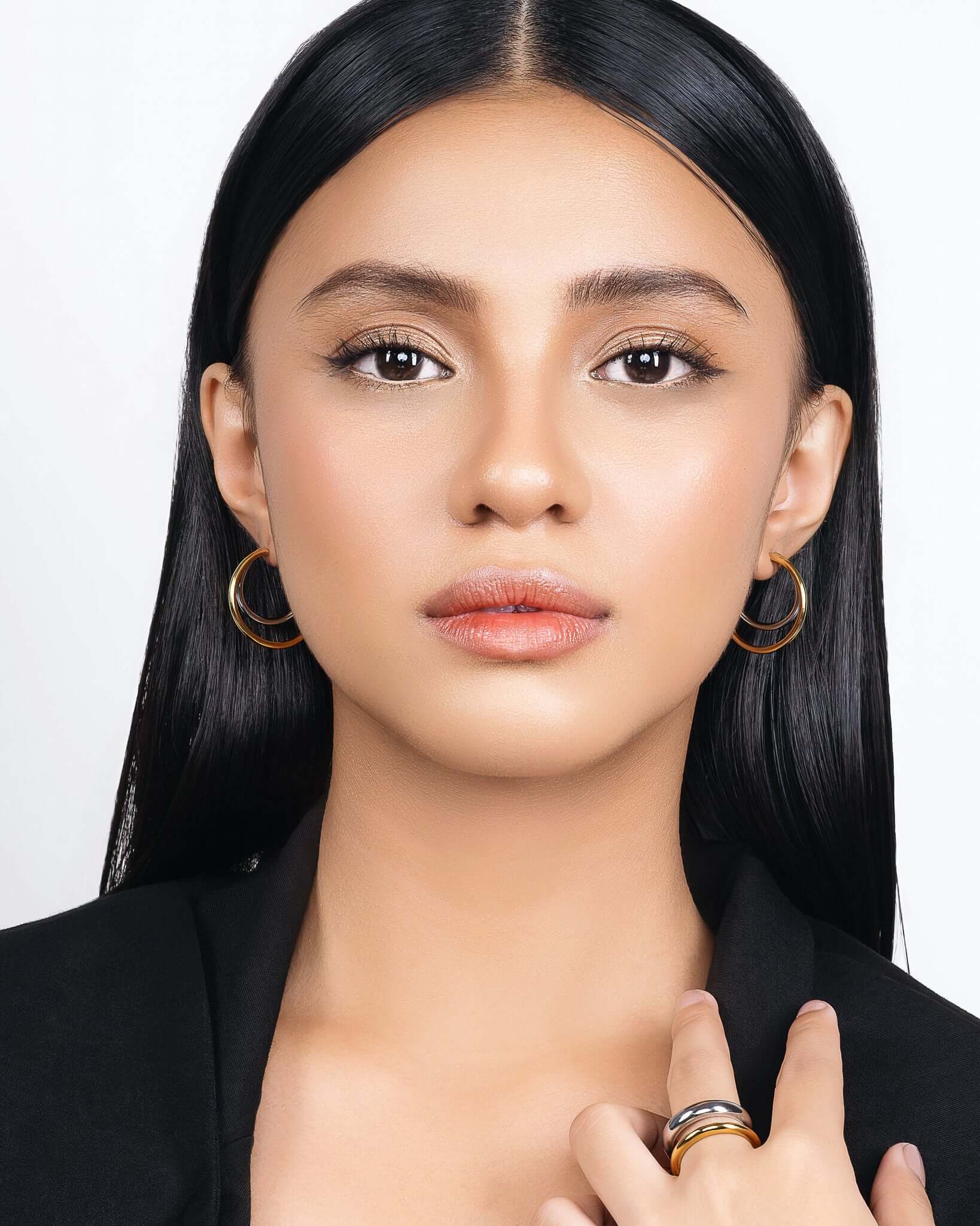 Modern two tone double hoop earrings featuring a polished gold outer hoop and silver inner hoop with secure tube lock closure, minimalist mixed metal statement earrings for everyday wear and modern jewelry styling.