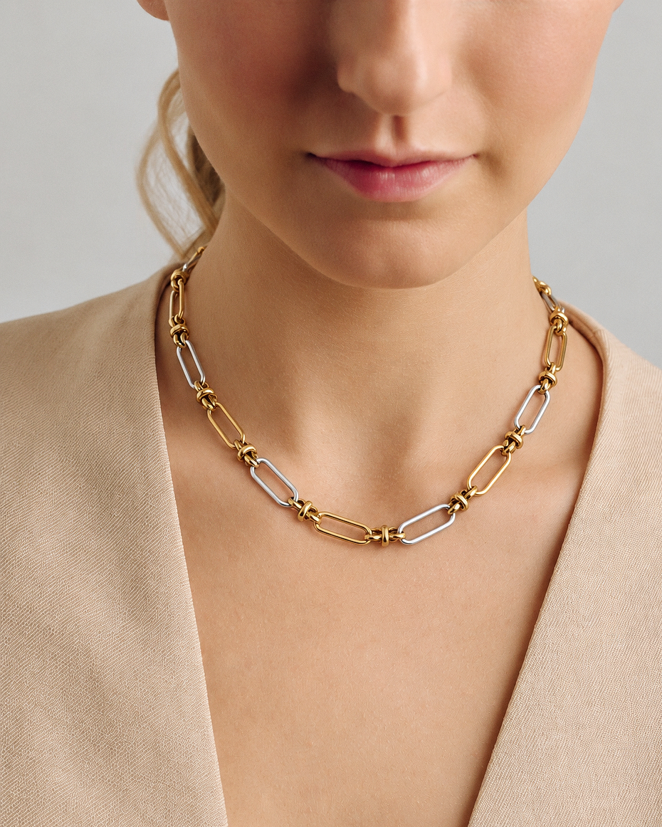Two tone link chain necklace in polished gold and silver with alternating elongated links, sculptural connectors and a modern mixed metal statement design by RRule