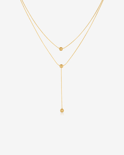 Double-strand 18K gold plated necklace with layered chains and polished ball pendants, delicate and modern for everyday or statement wear.