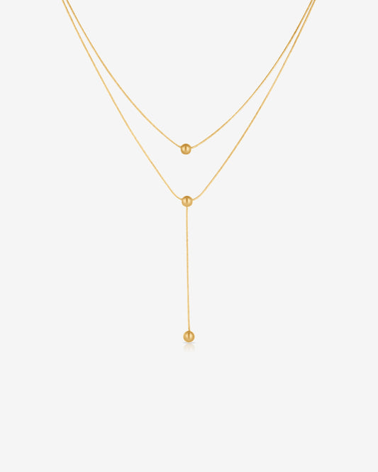 Double-strand 18K gold plated necklace with layered chains and polished ball pendants, delicate and modern for everyday or statement wear.