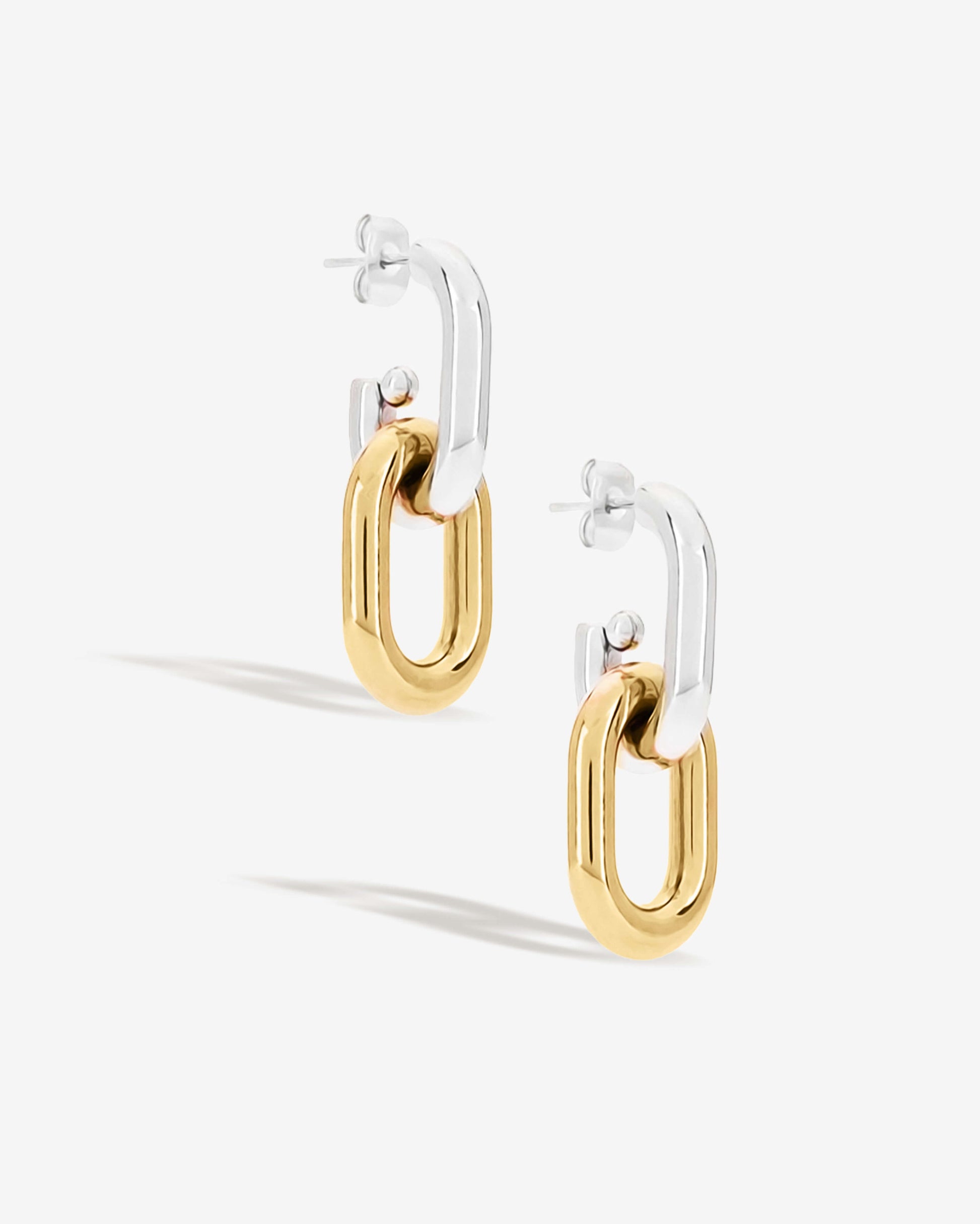 Two-tone link drop earrings with chunky silver and gold oval links stacked together. Modern statement earrings with sleek polished finish, lightweight and easy to wear. Perfect for everyday outfits or adding a chic, bold touch to evening looks. Contemporary geometric design ideal for fashion-forward styling.