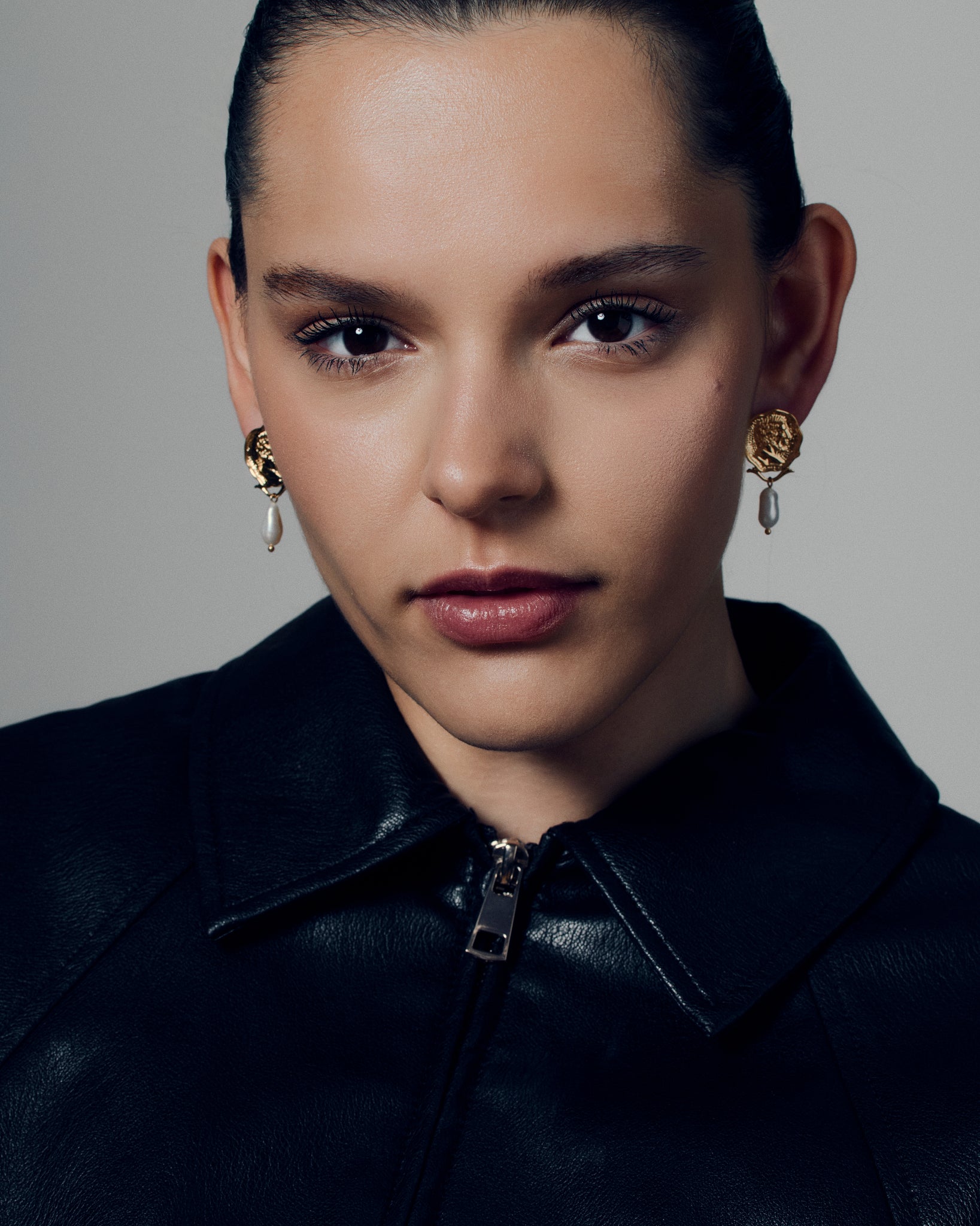 Gold coin pearl drop earrings featuring embossed medallion faces paired with natural baroque-style pearls. These sculptural statement earrings combine vintage inspiration with modern craftsmanship, offering a timeless yet bold look. Perfect for elevating everyday or occasion outfits with a touch of classic gold elegance.